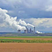 Stock image of a power plant behind a field